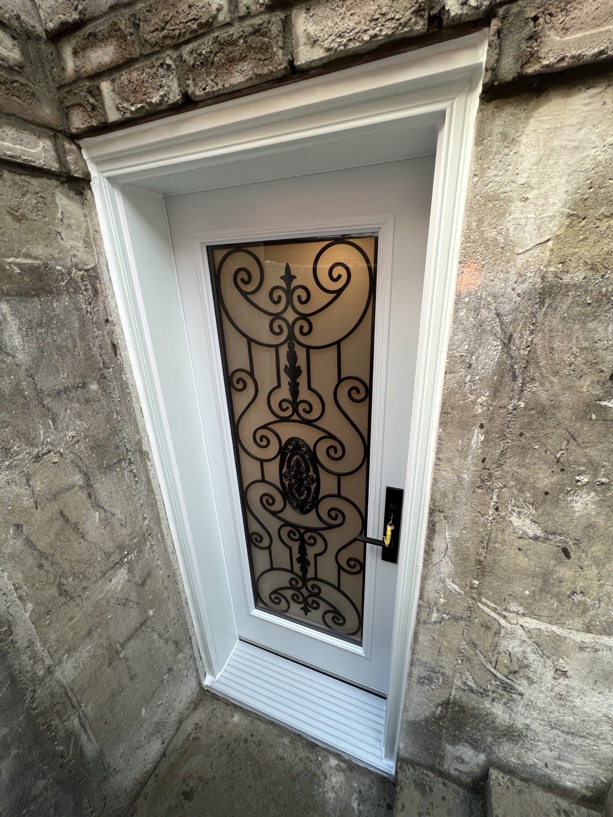 Decorative wrought-iron glass door at a Brampton basement walk-down