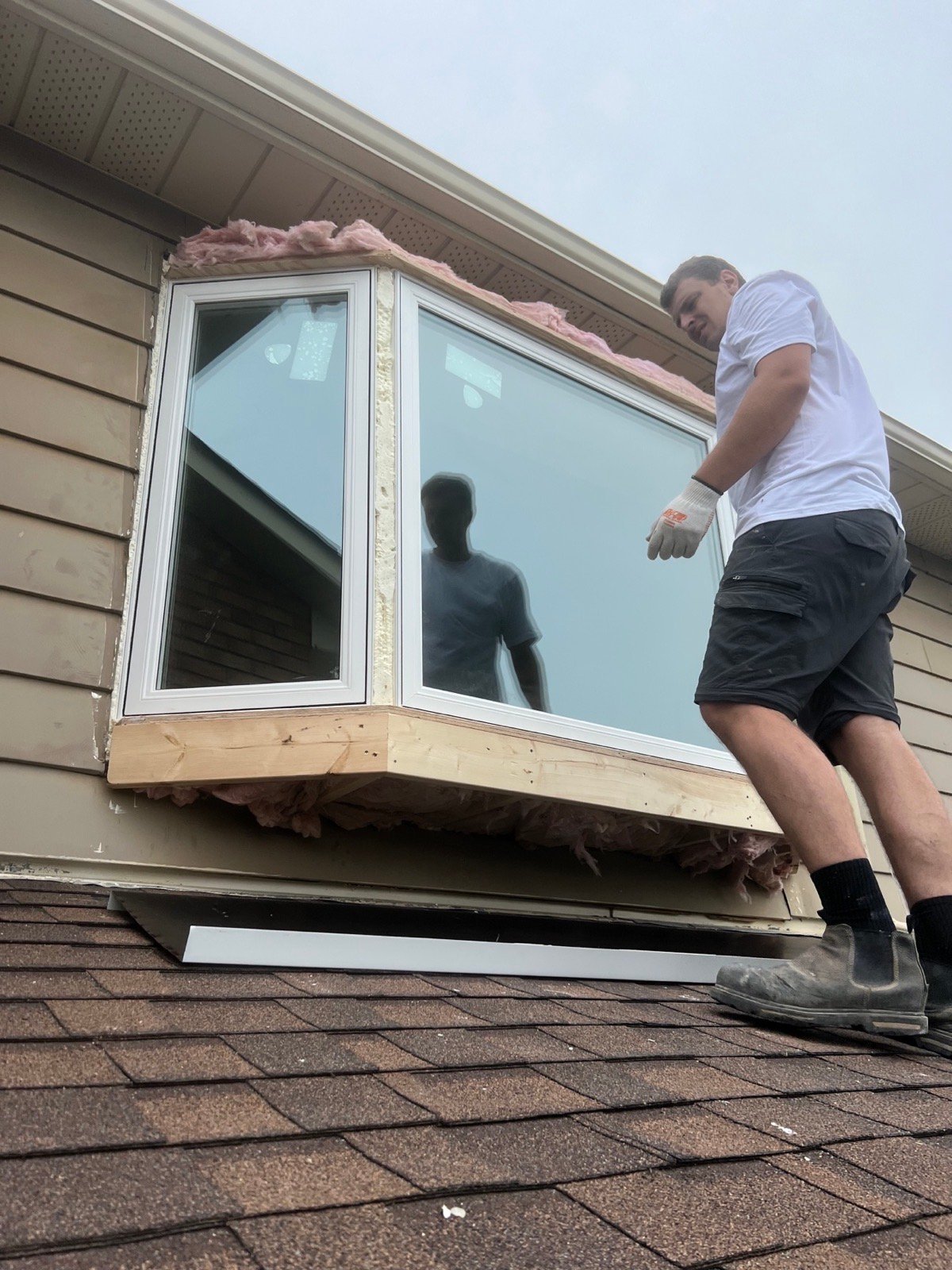 Bay window being rebuilt and insulated above a garage roof
