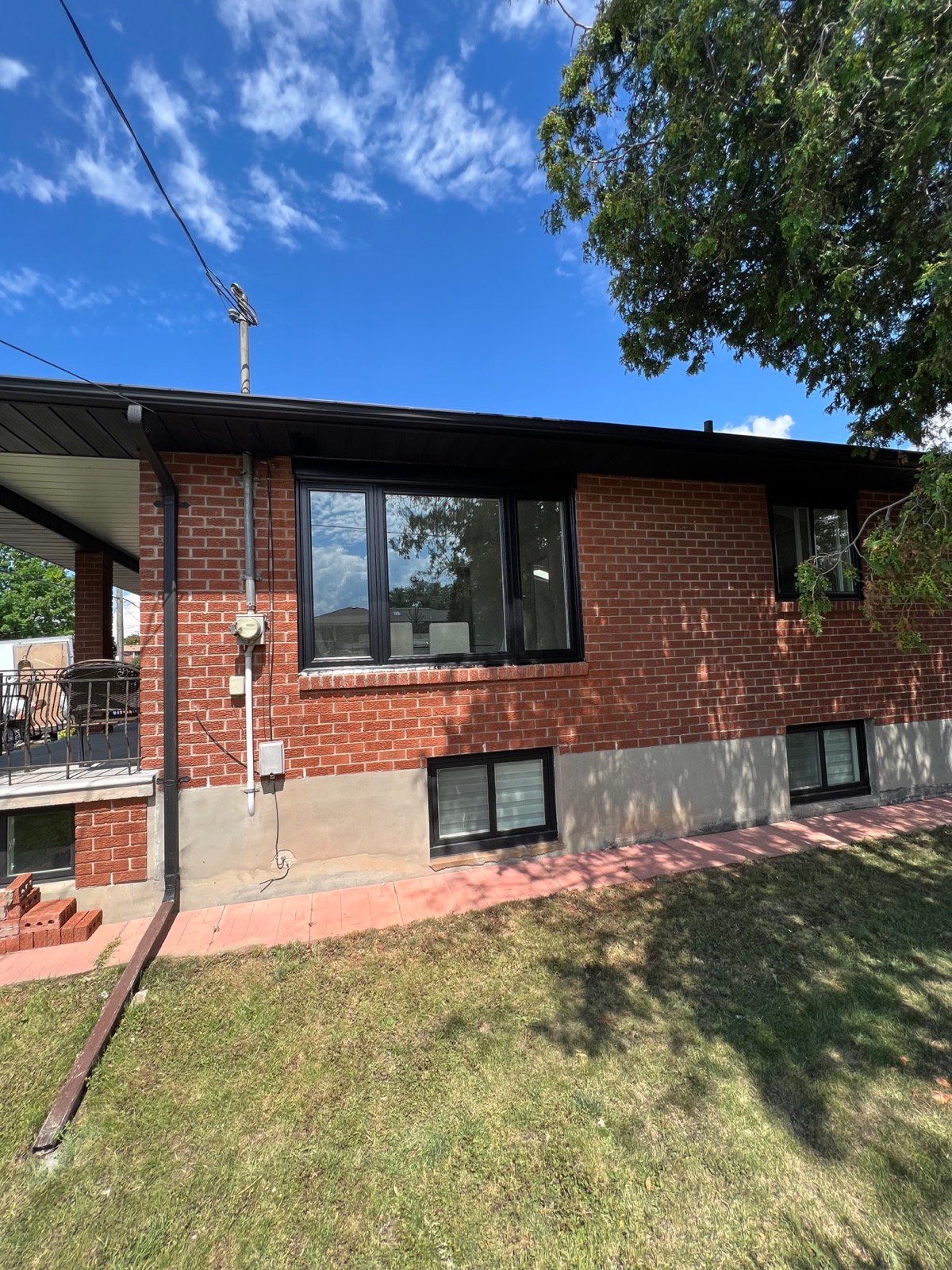Rear elevation of a Mississauga bungalow with black exterior windows