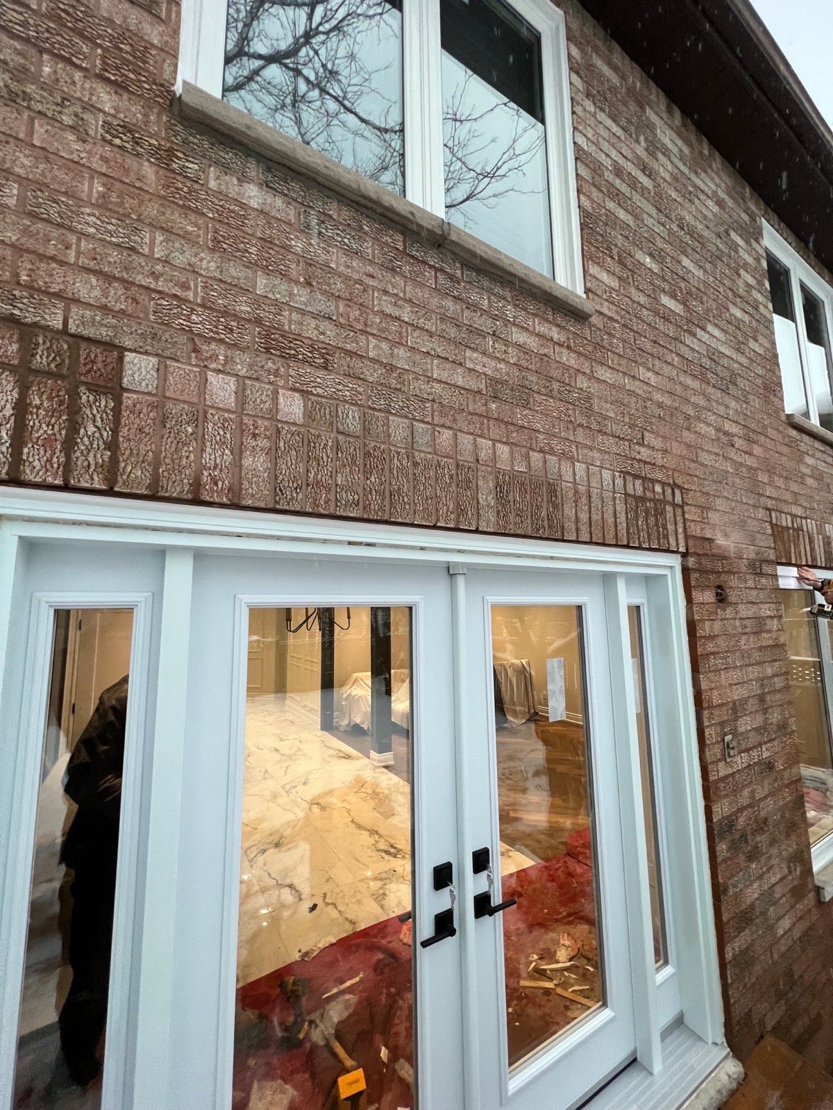 White French double doors with sidelites viewed from outside in winter