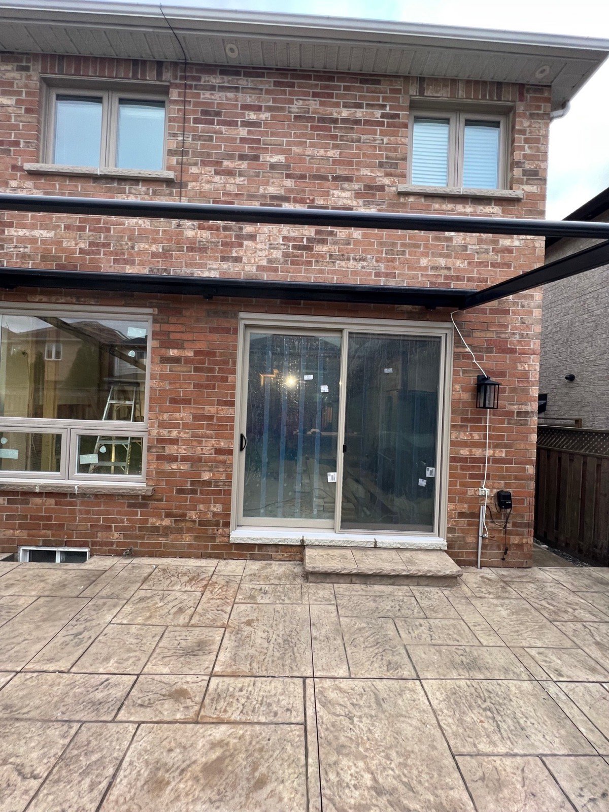 Rear of a Mississauga home with an enlarged patio door and window opening