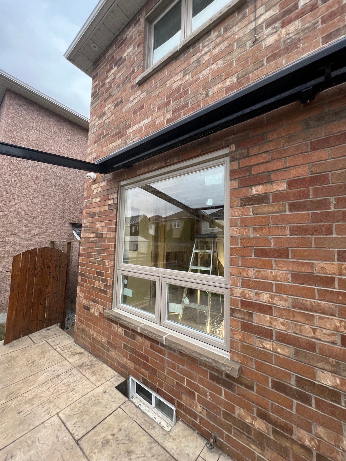 Wide rear combination window installed beside a patio opening